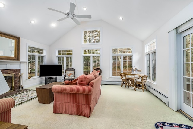 living room with a baseboard radiator, a fireplace, ceiling fan, carpet flooring, and high vaulted ceiling