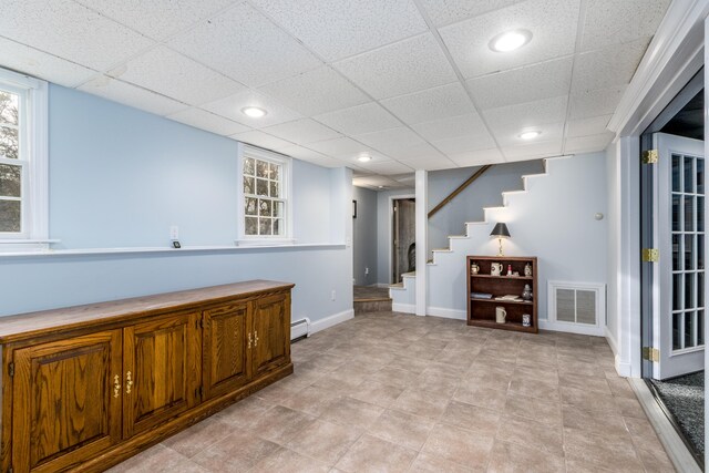 bar with a baseboard radiator and a wealth of natural light