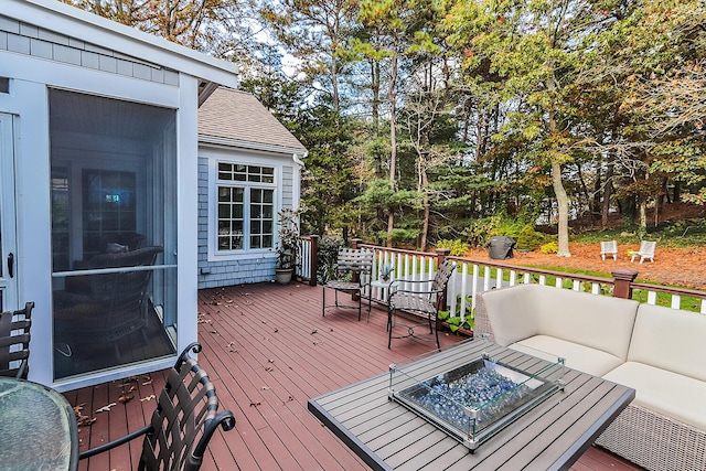 wooden deck featuring an outdoor living space with a fire pit