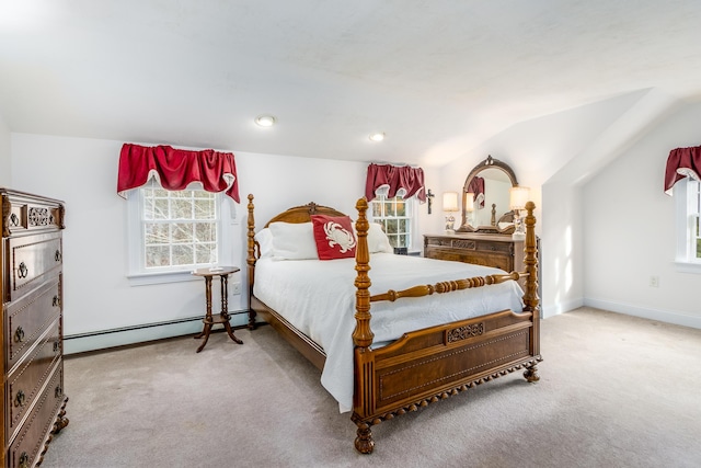 carpeted bedroom featuring baseboard heating and lofted ceiling