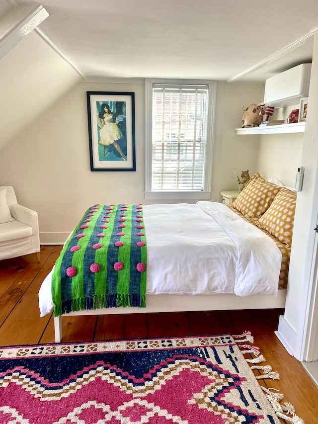 54 Commercial St Unit 3, 4, 5, 6, Provincetown, MA 02657 - bedroom with a wall mounted air conditioner, wood finished floors, and lofted ceiling