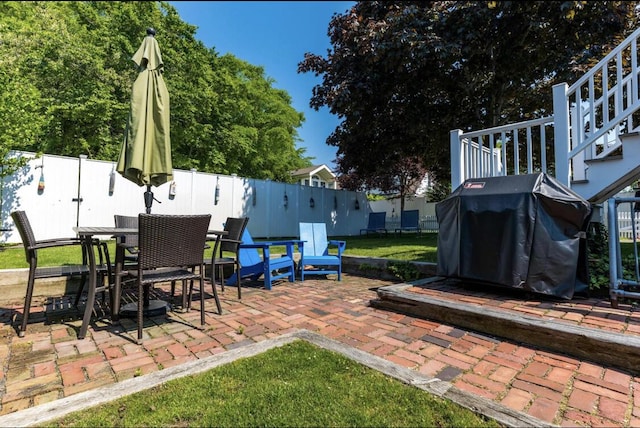 54 Commercial St Unit 3, 4, 5, 6, Provincetown, MA 02657 - view of patio with fence, stairs, outdoor dining space, and a grill