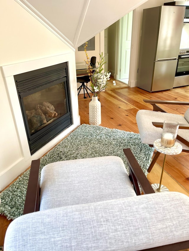 54 Commercial St Unit 3, 4, 5, 6, Provincetown, MA 02657 - interior space featuring a glass covered fireplace, wood finished floors, and lofted ceiling