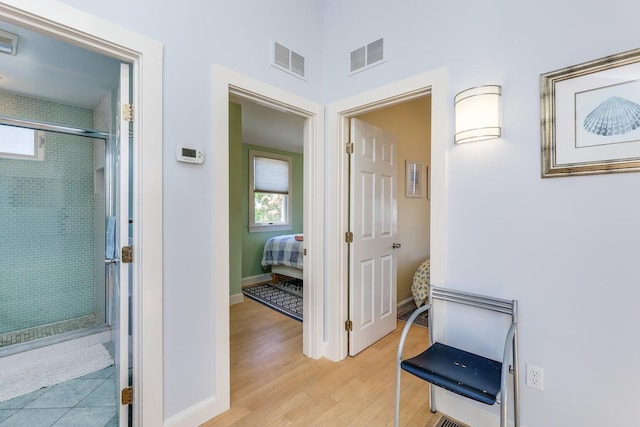 49 Bradford St Unit 9, Provincetown, MA 02657 - hallway featuring healthy amount of natural light, light wood finished floors, and baseboards