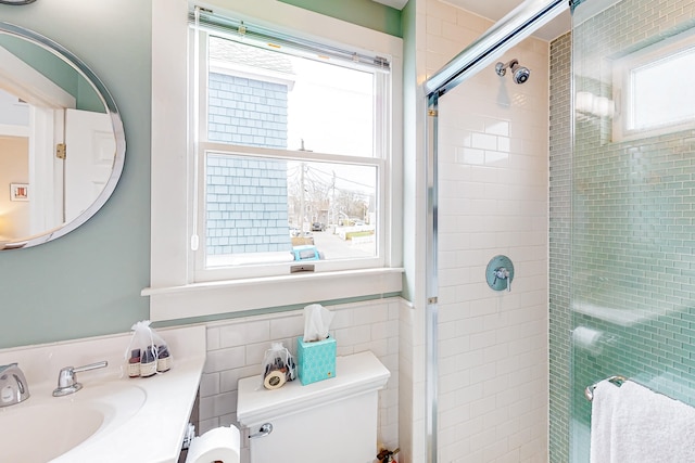 49 Bradford St Unit 9, Provincetown, MA 02657 - bathroom featuring toilet, tile walls, a stall shower, and vanity