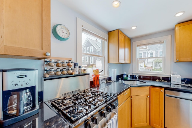 49 Bradford St Unit 9, Provincetown, MA 02657 - kitchen featuring appliances with stainless steel finishes, a sink, recessed lighting, and dark stone counters
