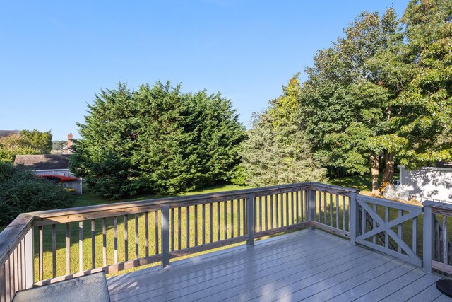 wooden deck featuring a yard