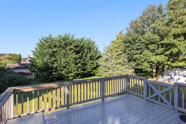 wooden deck featuring a yard