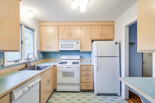 kitchen featuring sink, white appliances, and light brown cabinets