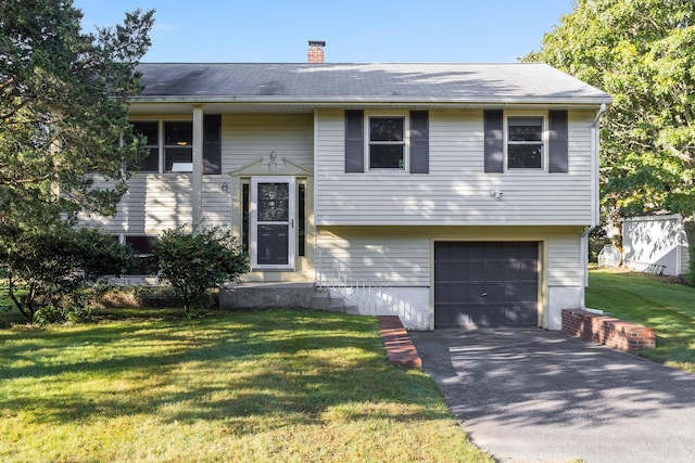 split foyer home with a garage and a front yard