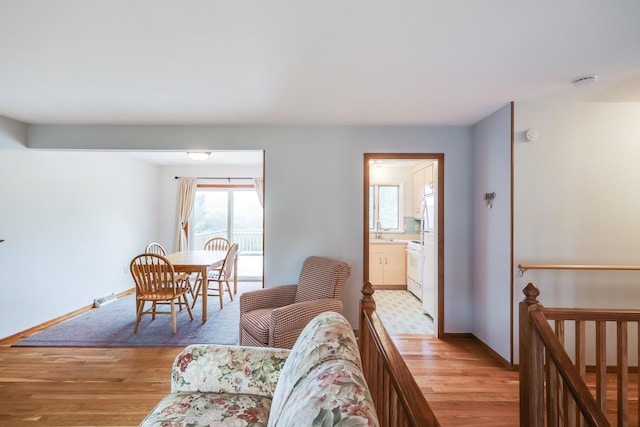 living room with sink and light hardwood / wood-style flooring