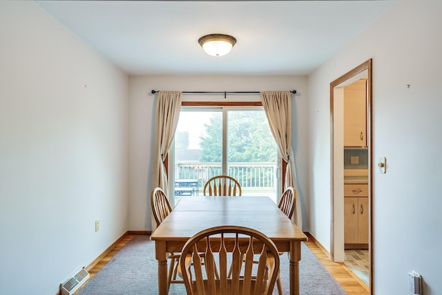 dining space featuring light wood-type flooring