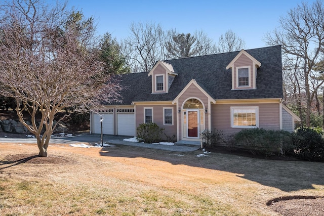 view of front of property featuring a garage, a front lawn, driveway, and a shingled roof