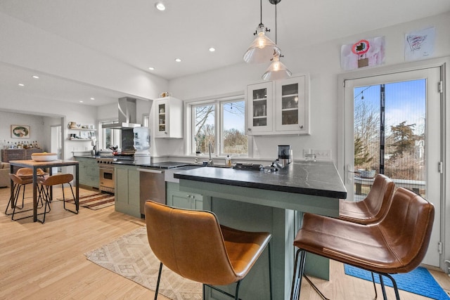 2 Seaview Rd, Orleans, MA 02653 - kitchen featuring exhaust hood, green cabinets, light wood-style floors, white cabinets, and appliances with stainless steel finishes