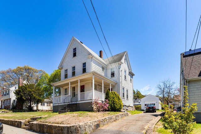 32 Grogan Ave, Quincy, MA 02169 - view of front of home featuring a porch, a garage, an outdoor structure, and a chimney