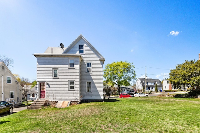 32 Grogan Ave, Quincy, MA 02169 - rear view of property featuring a yard