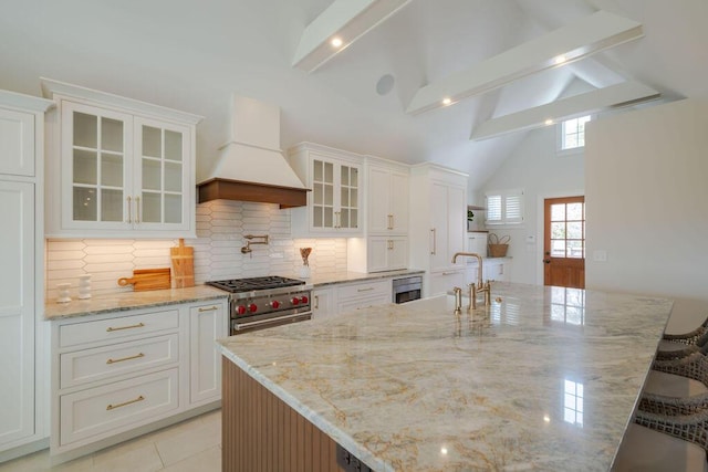 kitchen with custom range hood and white cabinets