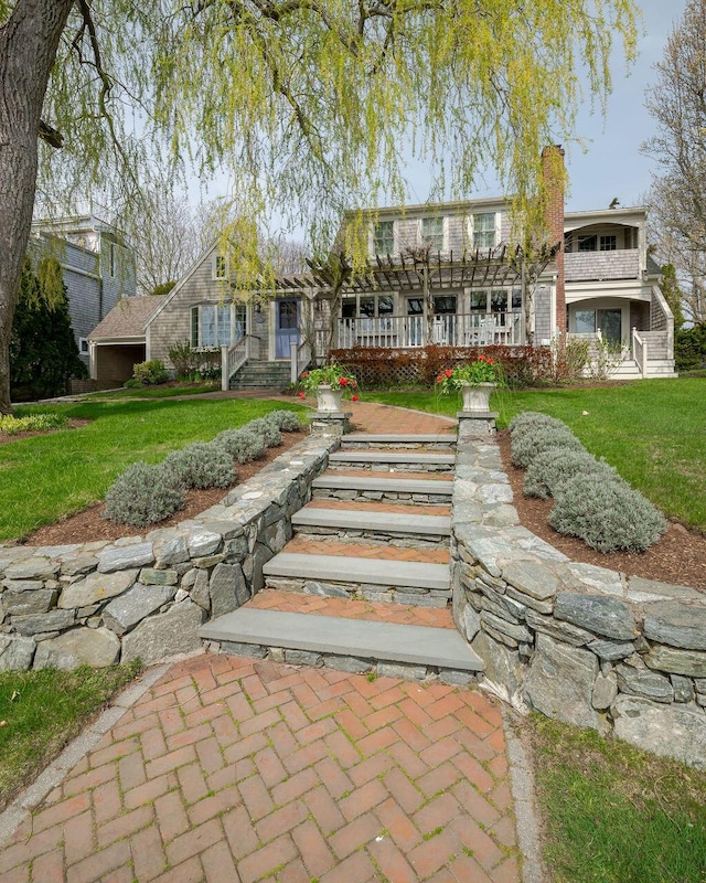exterior space featuring a yard and a chimney