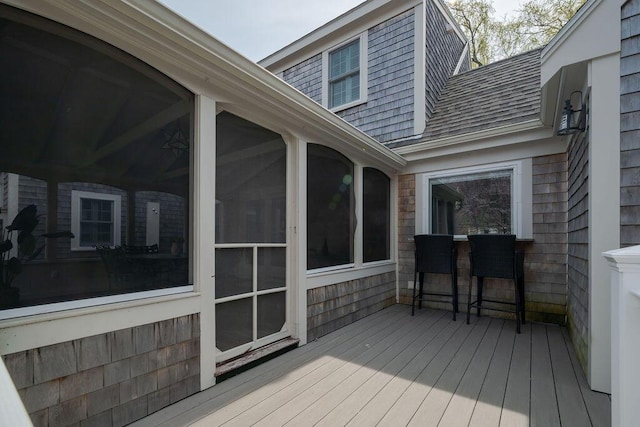 wooden deck featuring a sunroom