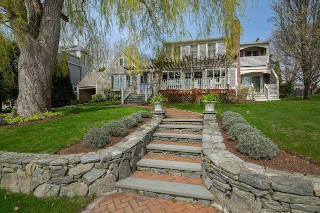 rear view of property featuring a lawn and a wooden deck