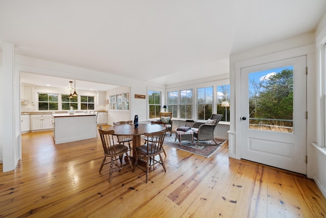 dining space with a wealth of natural light and light wood-type flooring