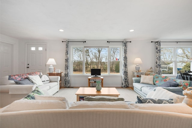 living room featuring plenty of natural light, recessed lighting, and baseboards