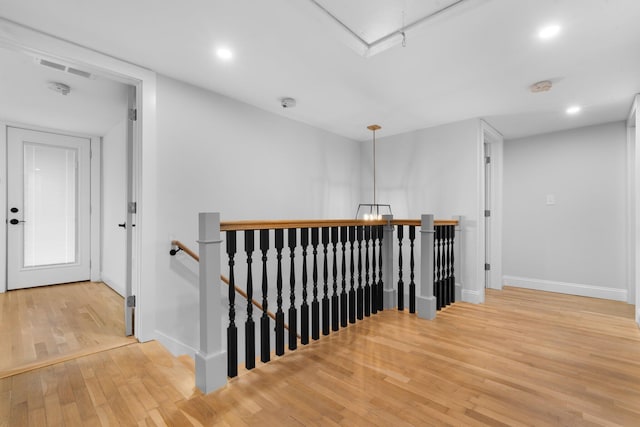 38 Mill St, Dennis Port, MA 02639 - corridor with attic access, wood finished floors, baseboards, and an upstairs landing