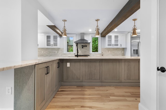38 Mill St, Dennis Port, MA 02639 - kitchen with light wood-style floors, wall chimney exhaust hood, and decorative backsplash