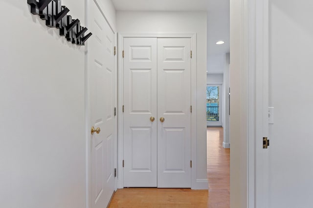 corridor with recessed lighting, light wood-style flooring, and baseboards