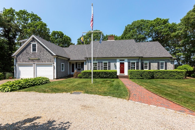 ranch-style home featuring a garage, a front yard, roof with shingles, and a chimney