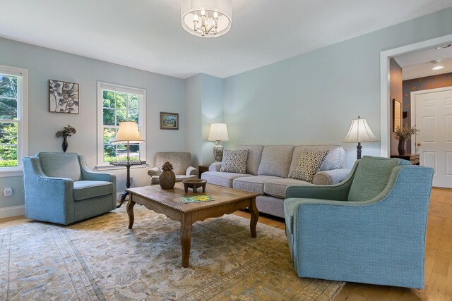 living area featuring a fireplace, hardwood / wood-style floors, and decorative columns