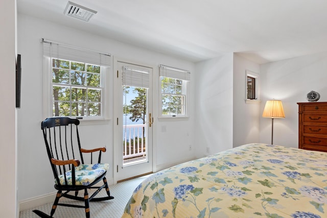 bedroom with baseboards, visible vents, and access to exterior