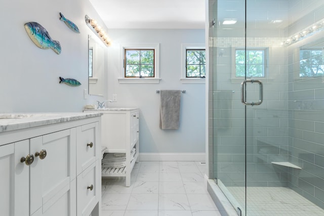 bathroom featuring vanity and a shower with door