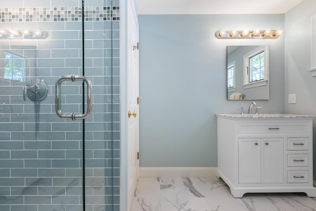 bathroom with marble finish floor, vanity, and baseboards