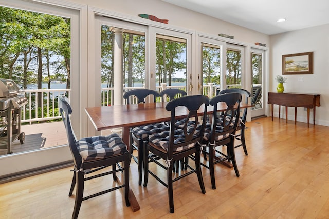 dining area with light wood-style flooring and recessed lighting