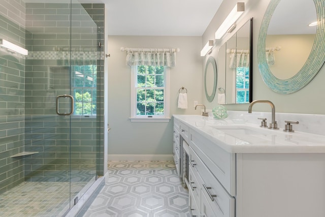 bathroom with vanity and a shower with door