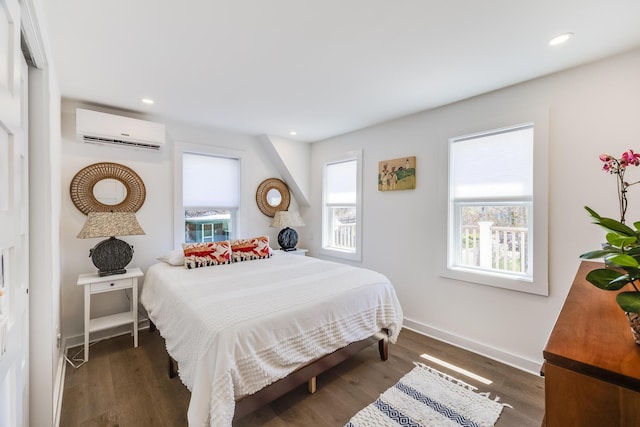 36 Pearl St Unit 2, Provincetown, MA 02657 - bedroom with an AC wall unit, recessed lighting, dark wood finished floors, and baseboards