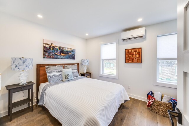 36 Pearl St Unit 2, Provincetown, MA 02657 - bedroom featuring a wall mounted AC, multiple windows, wood finished floors, recessed lighting, and baseboards