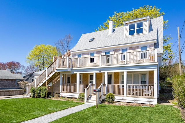 36 Pearl St Unit 2, Provincetown, MA 02657 - view of front of house with covered porch, stairs, a front yard, roof with shingles, and a chimney