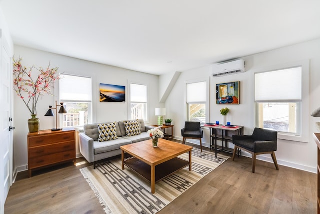 36 Pearl St Unit 2, Provincetown, MA 02657 - living room featuring plenty of natural light, an AC wall unit, wood finished floors, and baseboards