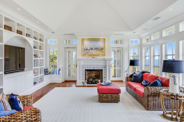 391 Sea View Ave, Osterville, MA 02655 - living room with healthy amount of natural light, vaulted ceiling, built in shelves, wood finished floors, and recessed lighting