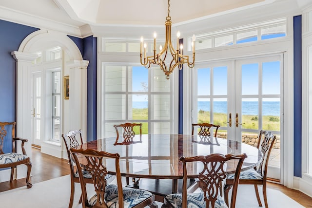 391 Sea View Ave, Osterville, MA 02655 - dining space with french doors, a water view, arched walkways, and healthy amount of natural light
