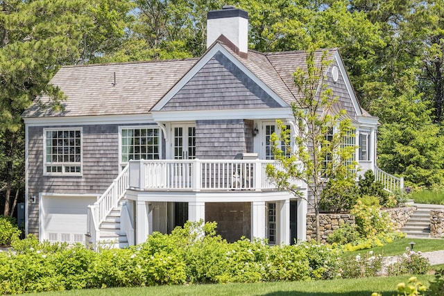 391 Sea View Ave, Osterville, MA 02655 - back of property with stairs, a chimney, a wooden deck, and view of scattered trees