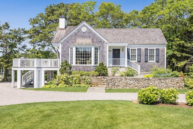 391 Sea View Ave, Osterville, MA 02655 - view of front of house featuring a chimney, a front lawn, and stairway
