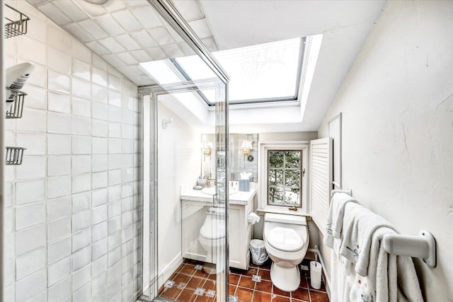 full bathroom with a shower stall, a skylight, toilet, tile patterned flooring, and vanity