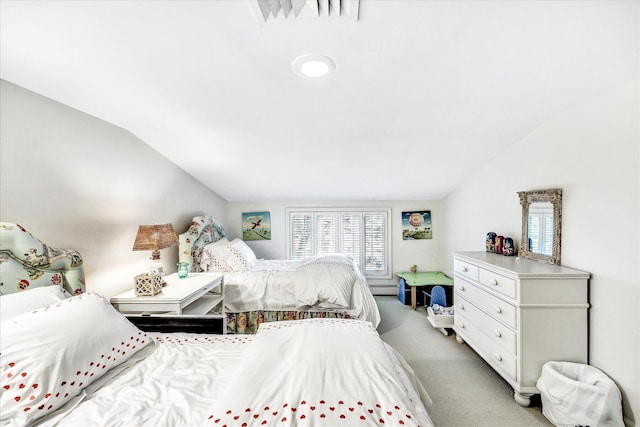bedroom featuring lofted ceiling, multiple windows, light colored carpet, and baseboard heating