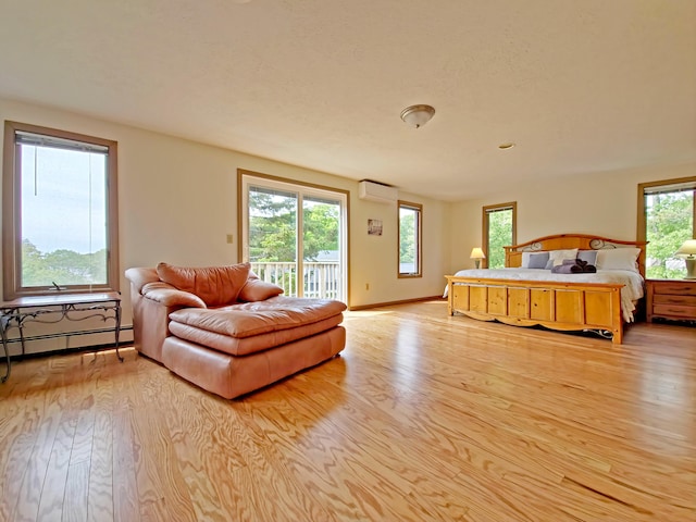 30 Norris Path, Teaticket, MA 02536 - bedroom with baseboard heating, access to exterior, wood finished floors, and a wall mounted AC