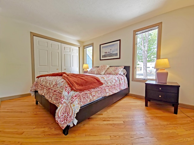 30 Norris Path, Teaticket, MA 02536 - bedroom featuring baseboards, light wood-style flooring, a closet, and a textured ceiling
