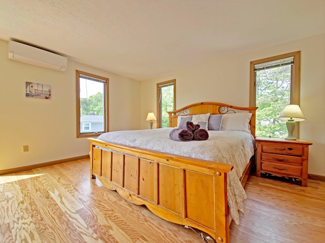 30 Norris Path, Teaticket, MA 02536 - bedroom with a wall unit AC, light wood finished floors, and baseboards