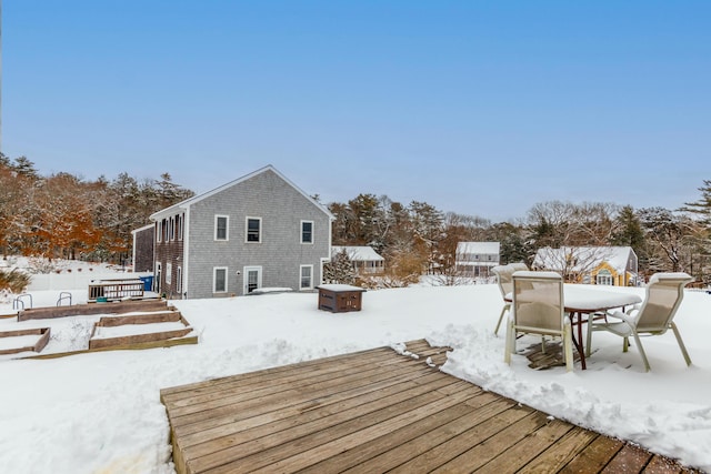 snow covered property featuring a wooden deck